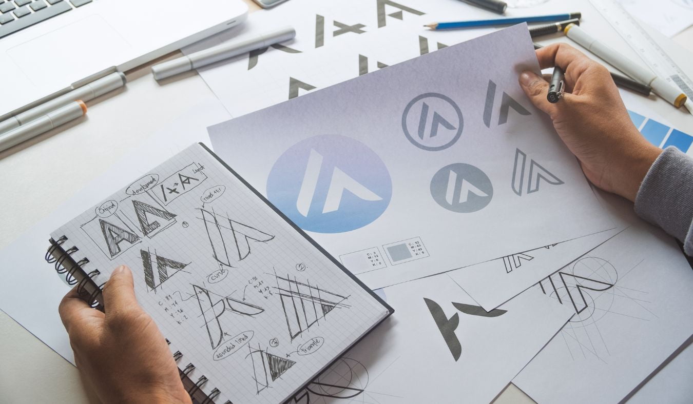 A Graphic Designer Sketching different logo shapes